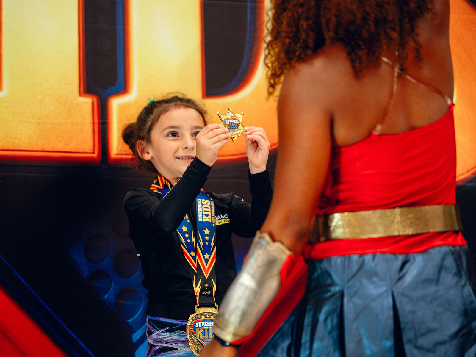 A young athlete kissing his medal at Superhero Kids Nampa