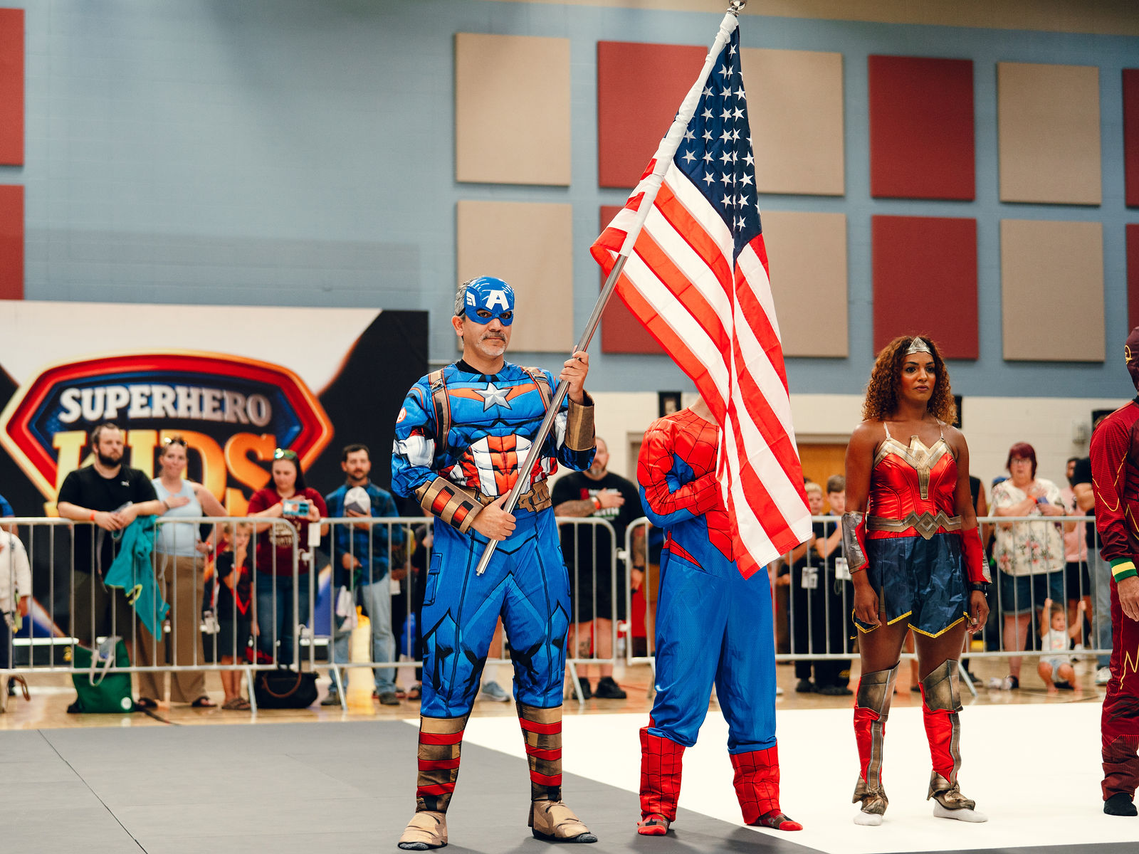 Costumed heroes opening the arena at Superhero Kids Nampa