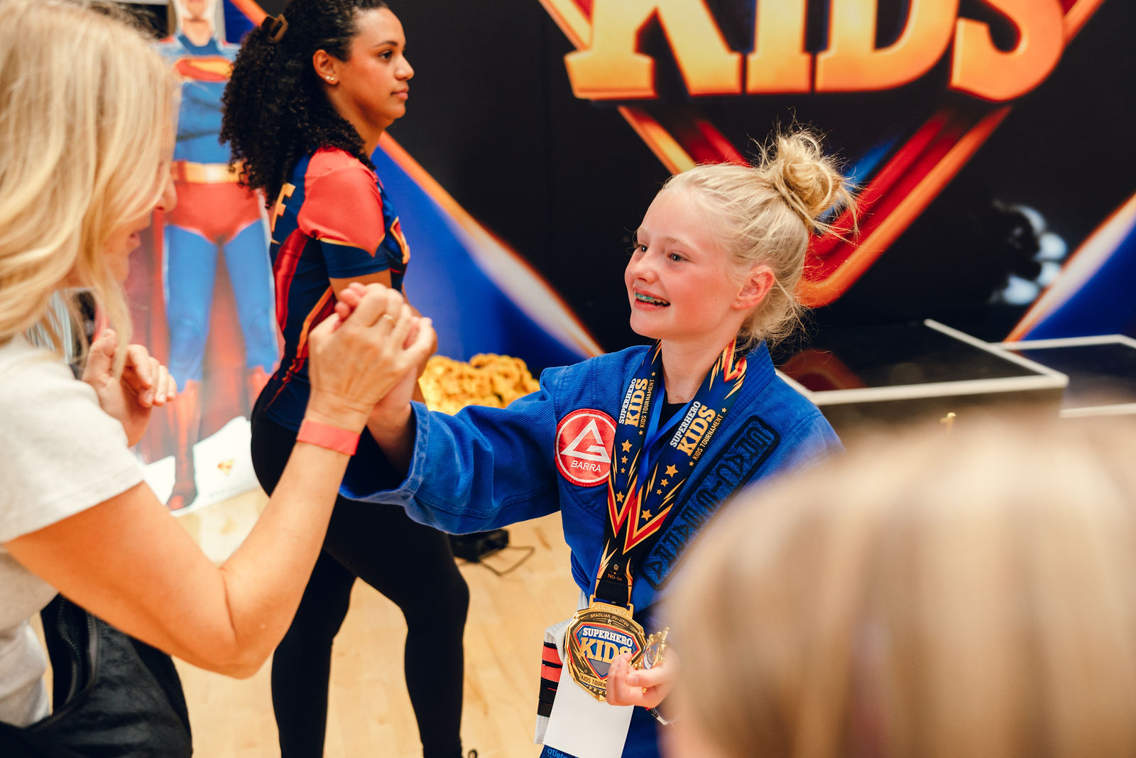 A young athlete smiling with pure joy after competing at Superhero Kids Nampa